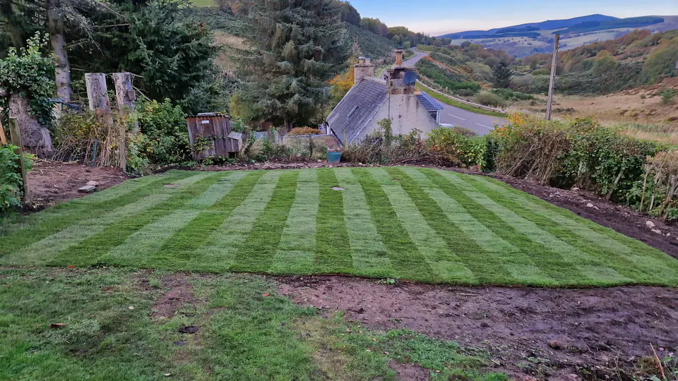 Striped lawn overlooking a rural valley
